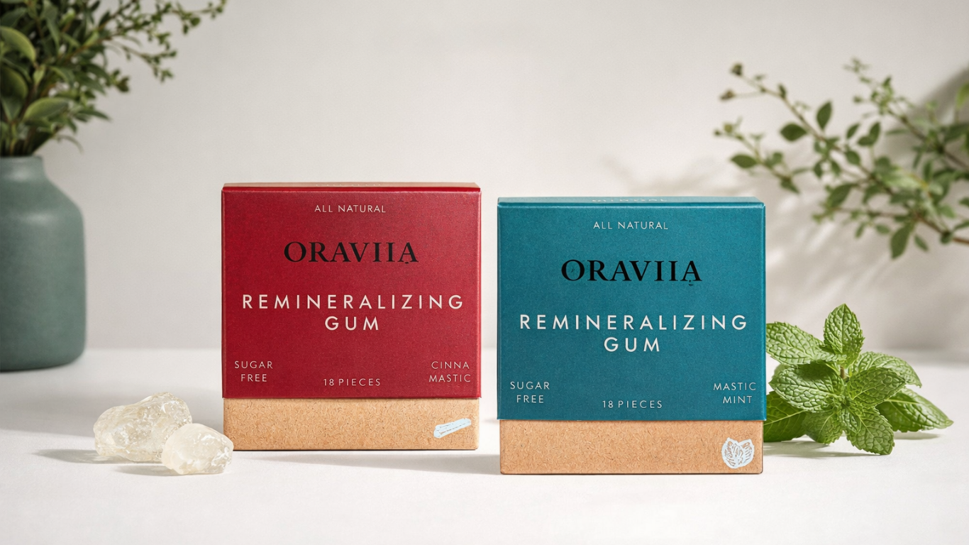Oraviia all-natural remineralizing chewing gum in cinnamon mastic and mastic mint flavors, displayed on a minimalist off-white background with natural ingredients.